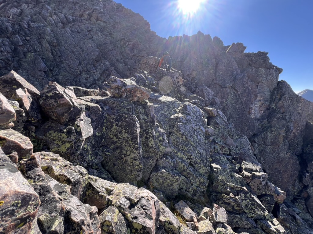 Randall scrambling up the ridge towards West Trinity