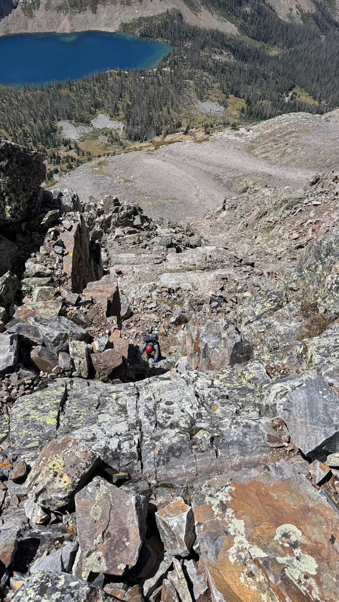 Maya climbing the chimney towards Trinity Peak