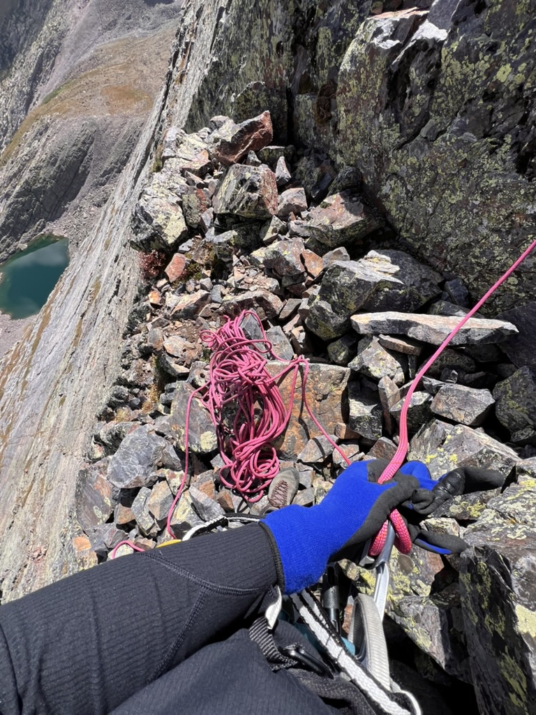 Maya on the ledge belaying Randall